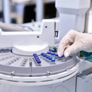 Quality Control Laboratory medicine. Chromatograph operation. A woman makes an analysis on a gas chromatograph. Development of a new vaccine against the covid-19 virus.Pharmaceutical factory